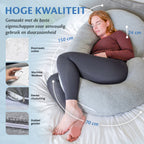 Een vrouw ligt ontspannen op een bed met een kussen en een zwangerschapskussen van Ella Sleeps, van hoge kwaliteit.